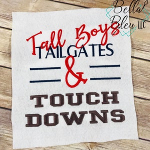 May include: White fabric with red, blue, and brown embroidered text that reads "Tall Boys Tailgates & Touch Downs".