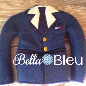 May include: Blue felt elf costume jacket with a white collar, black tie, and gold buttons. The jacket has a pocket with a small embroidered airplane on it. The text "Bella Bleu" is embroidered on the bottom of the jacket.