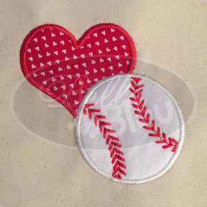May include: A red heart with white polka dots and a white baseball with red stitching.