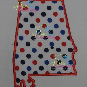 May include: Red, white, and blue polka dot fabric cut out in the shape of the state of Alabama. The fabric is outlined in red.