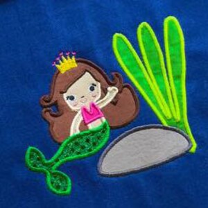 May include: A green mermaid with brown hair wearing a pink top and a gold crown sits on a gray rock with green seaweed behind her.
