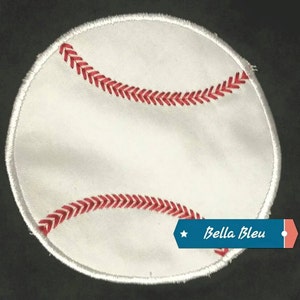 May include: White baseball patch with red stitching. The patch has the text "Bella Bleu" in blue.