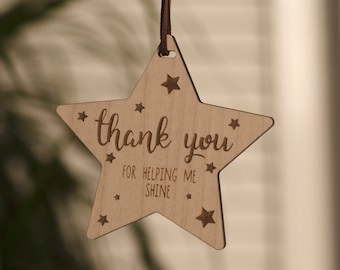 May include: Wooden star-shaped ornament with the text "Thank you for helping me shine" and small stars around the edges.