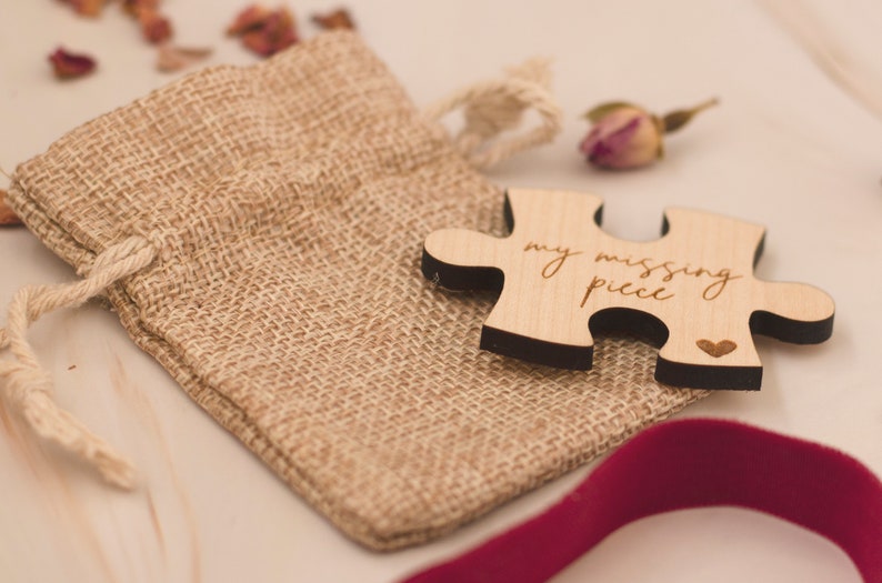 May include: A wooden puzzle piece with the text "my missing piece" and a small heart carved into the wood. The puzzle piece is sitting on a burlap bag.