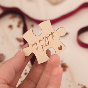 May include: A wooden puzzle piece with the text "my missing piece" and a small heart shape carved into it.