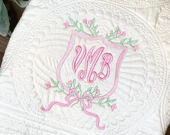 Heirloom Quilt Embroidered with Classic Crest and Baby's Initials, Surrounded by Flowers and finished with a Bow, Personalized Monogram