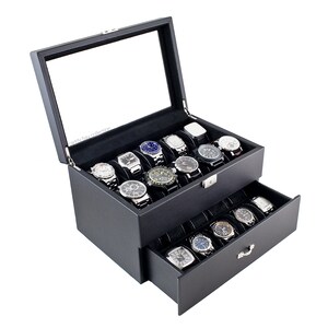 May include: Black leather watch box with a glass top and a pull-out drawer. The box is filled with 20 watches.