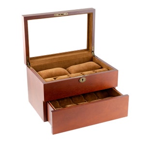 May include: A wooden watch box with a glass top and a drawer. The box has a brown stain and is lined with brown velvet. The drawer has multiple compartments for storing watches.
