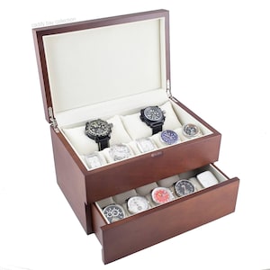 May include: A wooden watch box with a hinged lid and a pull-out drawer. The box is a dark brown color and contains several watches with various band and face designs. The interior is lined with a cream-colored fabric.