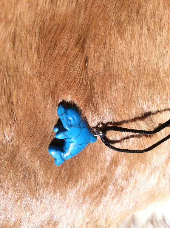 Carved stone dolphin necklace.  Made of turquoise.