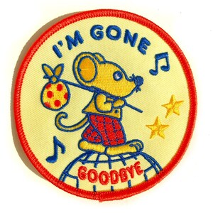 May include: A circular embroidered patch with a cream background and a red border. It features a yellow mouse carrying a red and yellow polka-dot bindle on a stick, standing on a blue globe. Text reads I'M GONE and GOODBYE with musical notes and stars.