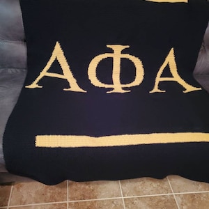 Enjoy a handmade Alpha Phi Alpha Fraternity afghan.