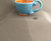 Morning Burst- Small Mug, Bohemian whirls of sky blue outside and bright orange inside with curly twisted handle, holds 7 ounces