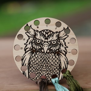 May include: Wooden owl-shaped thread organizer with 16 holes for storing embroidery floss. The organizer has numbers 1-16 around the edge and is decorated with a detailed owl illustration.