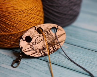Knitting & crochet yarn separator with sheep in hills and field. Yarn divider with three holes for colorwork, made from cherry wood.