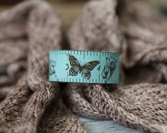 Butterfly and Flowers Leather Ruler Cuff, made from blue leather with bronze stud. Great for measuring knitting, sewing & fiber project