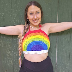 May include: A rainbow crochet halter top with a white crocheted trim. The top is made with a variety of colours, including red, orange, yellow, green, blue, indigo, and violet.