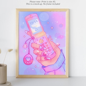 May include: A pink and blue flip phone with a heart-shaped button and a charm attached. The phone is held in a hand with pink and blue nail polish. The background is a pastel pink and blue with stars and hearts.
