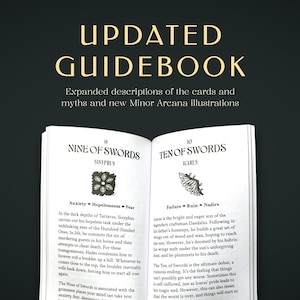 May include: An open guidebook with black text on white pages. The top text reads UPDATED GUIDEBOOK. Expanded descriptions of the cards and myths and new Minor Arcana illustrations. The pages show Nine of Swords Sisyphus and Ten of Swords Icarus.