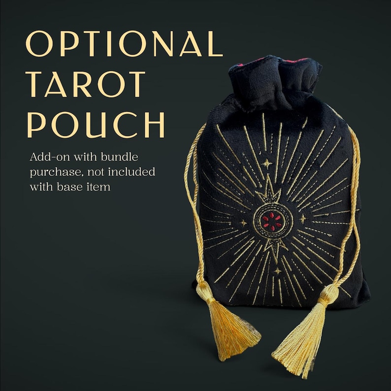 May include: A black velvet drawstring pouch featuring gold embroidered sunburst rays and a central circular motif with red accents. The text reads OPTIONAL TAROT POUCH. Add-on with bundle purchase, not included with base item. Two gold tassels hang from the cords.