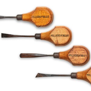 May include: Set of four wood handled carving tools with metal blades. Each handle is labeled "Millers Falls".