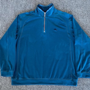 May include: A teal blue 1/4 zip pullover sweater with a small kangaroo logo on the left chest.