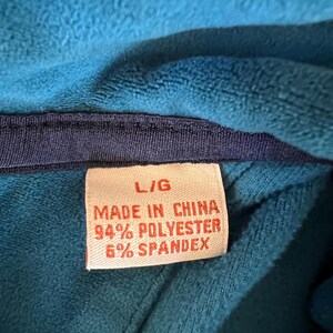May include: A red tag with white text that reads 'L/G Made in China 94% Polyester 6% Spandex'
