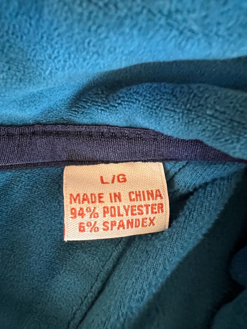 May include: A red tag with white text that reads 'L/G Made in China 94% Polyester 6% Spandex'