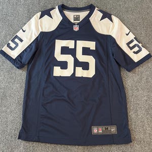 May include: A navy blue football jersey with white accents, featuring the number 55 in large white numerals on the front and sleeves. The jersey has a V-neck and the NFL logo.
