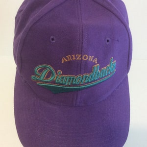 May include: Purple baseball cap with the text "Arizona Diamondbacks" embroidered in green and gold.