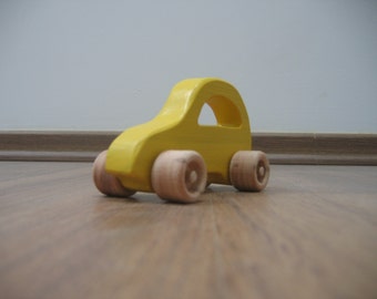 Little yellow wooden toy car