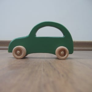 Green toy car made of wood image 1