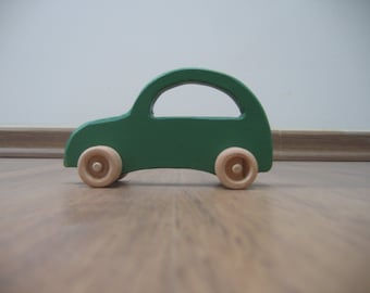 Green toy car made of wood