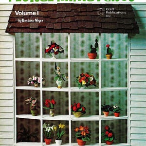 May include: A book cover with the title "Bread Dough Floral Miniatures, Volume I" by Barbara Meyer. The cover features a window with a variety of miniature floral arrangements made from bread dough.