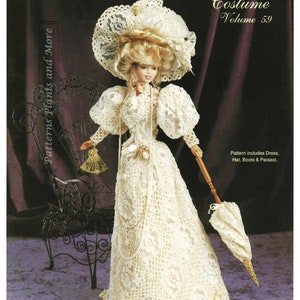 May include: A crochet doll wearing a white lace dress, hat, and boots. The doll is holding a parasol. The doll is sitting in a chair. The image is from a crochet pattern book. The text on the page reads "Crochet Collector Costume Volume 59" and "1903 Bride's Going Away Dress".