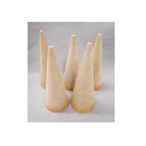 May include: Five beige incense cones are arranged on a white surface. The cones are tall and conical, with a textured surface and a slightly darker base. The cones are evenly spaced and appear to be made of a natural material.