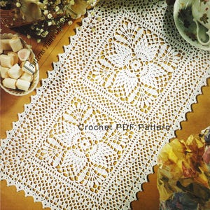 May include: White crochet table runner with a delicate lace pattern. The runner features three square motifs with a floral design in the center. The text "Crochet PDF Pattern" is visible in the lower center of the image.