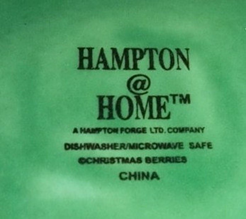 May include: Green and white logo for Hampton @ Home, a Hampton Forge LTD. company. The logo states that the product is dishwasher and microwave safe. The text "Christmas Berries" is also included. The logo indicates that the product is made in China.