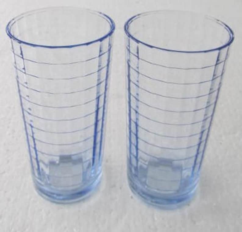 May include: Two clear blue glass drinking glasses with a ribbed design.