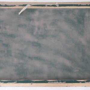 May include: A vintage wooden frame with a green chalkboard insert. The frame has a light brown finish and a slightly distressed look.