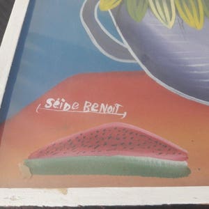 May include: A framed painting of a watermelon slice on a red and orange background. The painting is signed "Seide Benoit".