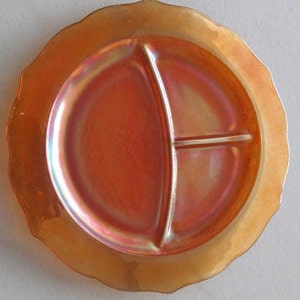 May include: A vintage iridescent orange glass divided serving plate with a scalloped edge.