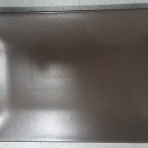 May include: A rectangular brown ceramic plate with a slightly raised rim.