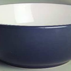 May include: A blue and white ceramic bowl. The bowl is round and has a white interior and a blue exterior.