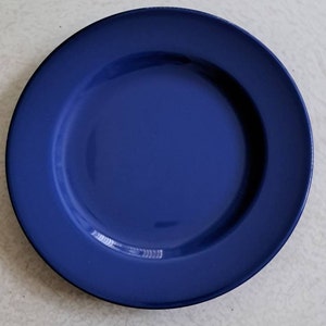 May include: A solid blue ceramic plate with a slightly raised rim.