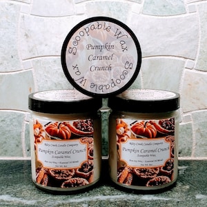 May include: Two glass jars of scoopable wax with a brown label that reads "Riley Creek Candle Company Pumpkin Caramel Crunch Scoopable Wax Pure Soy Wax - Essential Oil Blends Net Wt. 14 oz."