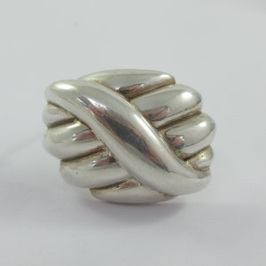 May include: A silver knot-shaped ring with a smooth, polished finish.