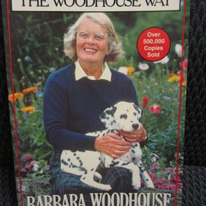May include: Book cover for "NO BAD DOGS THE WOODHOUSE WAY" by Barbara Woodhouse. It shows a woman holding a Dalmatian dog. The cover has the text "Over 500,000 Copies Sold" in a red circle.