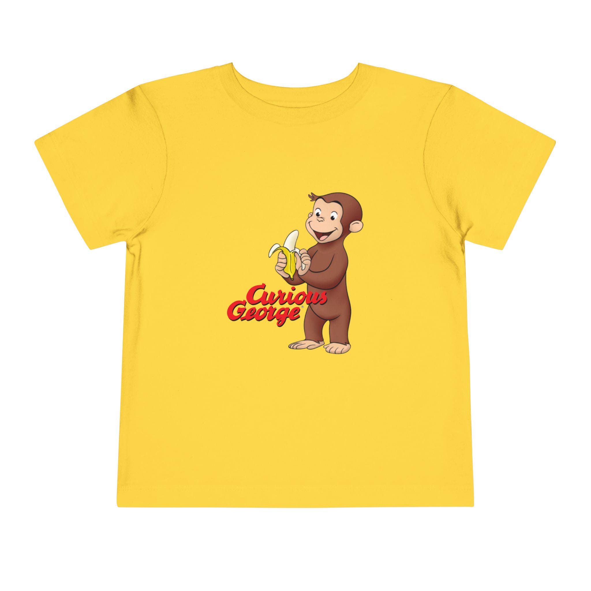 Curious George Peeling a Banana Modern Cartoon with Logo Toddler Unisex Bella+Canvas Short Sleeve Tee