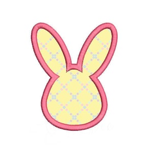 May include: A pink outlined bunny head with a yellow and blue checkered pattern.